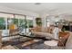 Bright living room with comfortable seating, stylish rug, and access to screened-in patio at 1240 Harbor Lake Dr, Largo, FL 33770