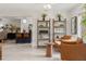 Bright living room with tiled floors, book shelves, and modern furniture at 1240 Harbor Lake Dr, Largo, FL 33770