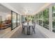 Enclosed sun room featuring a dining table, backyard views, ceiling fan, and modern lighting at 1240 Harbor Lake Dr, Largo, FL 33770
