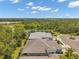 An aerial view features lush green landscape and several homes surrounding a serene pond at 12817 Cobalt Ter, Bradenton, FL 34211