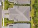 An overhead shot reveals a home's roof and landscaping, along with parts of nearby houses at 12817 Cobalt Ter, Bradenton, FL 34211
