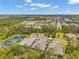 An aerial view shows houses with a green landscape, nearby ponds, and a road stretching into the distance at 12817 Cobalt Ter, Bradenton, FL 34211