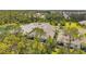 An aerial view showcases houses on a cul-de-sac surrounded by lush trees and a calming pond at 12817 Cobalt Ter, Bradenton, FL 34211