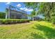 Spacious backyard with an enclosed patio and manicured landscaping, perfect for outdoor living and privacy at 12817 Cobalt Ter, Bradenton, FL 34211