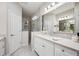 Bathroom showcasing a shower, vanity with sink, and ample lighting for a spa-like experience at 12817 Cobalt Ter, Bradenton, FL 34211