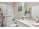 Bathroom showcasing a shower-tub combination, framed art, vanity with a sink, and white floral accents at 12817 Cobalt Ter, Bradenton, FL 34211