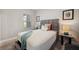 Well-lit bedroom featuring a decorative headboard, side table, and patterned throw pillows on the bed at 12817 Cobalt Ter, Bradenton, FL 34211