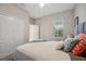 Bright bedroom featuring a ceiling fan, natural light, and a view of the outdoors from the window at 12817 Cobalt Ter, Bradenton, FL 34211