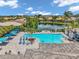Aerial image displays a community pool and lounging area overlooking a lake, perfect for relaxation at 12817 Cobalt Ter, Bradenton, FL 34211