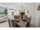 Open dining area with stylish chandelier adjacent to modern kitchen and sitting area at 12817 Cobalt Ter, Bradenton, FL 34211