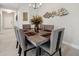 Dining room with table, seating for six, modern chandelier, and fish artwork at 12817 Cobalt Ter, Bradenton, FL 34211