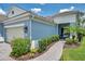 Charming home exterior featuring a lush landscaped pathway leading to a cozy porch with seating at 12817 Cobalt Ter, Bradenton, FL 34211