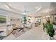 Bright, open-concept living room with modern décor, seamlessly connected to dining area and kitchen at 12817 Cobalt Ter, Bradenton, FL 34211