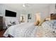 Bedroom boasting plush bedding, a ceiling fan, and bright natural light for a serene atmosphere at 12817 Cobalt Ter, Bradenton, FL 34211