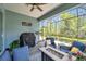 Covered outdoor patio with comfortable seating and a BBQ grill, ideal for enjoying a relaxing atmosphere at 12817 Cobalt Ter, Bradenton, FL 34211