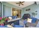 Comfortable seating surrounds a gas fire pit and BBQ grill in this covered outdoor patio space at 12817 Cobalt Ter, Bradenton, FL 34211