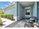 Welcoming front porch with comfortable wicker seating and a view into the landscaped front yard at 12817 Cobalt Ter, Bradenton, FL 34211