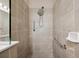 Shower features neutral tiling, a shower head, and grab bars for a luxurious bathing experience at 12817 Cobalt Ter, Bradenton, FL 34211