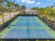 An aerial view of tennis courts lined with palm trees creates a refreshing atmosphere for play at 12817 Cobalt Ter, Bradenton, FL 34211