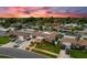 Stunning aerial view of a well-maintained neighborhood showcasing lush landscaping and beautiful homes at sunset at 13035 91St Ave, Seminole, FL 33776