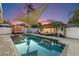 Backyard pool features lounge area, shade covering, and serene water reflections, perfect for relaxation at 13035 91St Ave, Seminole, FL 33776
