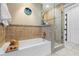 Beautiful bathroom featuring a tub, tiled shower, and modern fixtures and hardware at 13035 91St Ave, Seminole, FL 33776