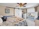 Cozy bedroom with a ceiling fan, large window, and barn door leading to closet space at 13035 91St Ave, Seminole, FL 33776