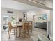 Open dining area featuring a central island, bar stools, and view into the living room at 13035 91St Ave, Seminole, FL 33776