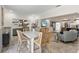 Open-concept dining area featuring a stylish bar-height table and chairs, and a view of the modern kitchen at 13035 91St Ave, Seminole, FL 33776