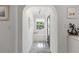 Bright foyer featuring a bench seat, nautical decor, and ample natural light through the front door at 13035 91St Ave, Seminole, FL 33776