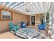 Cozy front porch with stylish seating, decorative compass painting, ceiling fan and pergola at 13035 91St Ave, Seminole, FL 33776