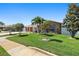 Charming single-story home featuring a lush lawn with beautiful landscaping and curb appeal at 13035 91St Ave, Seminole, FL 33776
