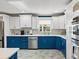 Well-lit kitchen features shaker cabinetry, modern appliances, quartz countertops, and tile backsplash at 13035 91St Ave, Seminole, FL 33776