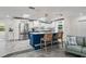Open kitchen with stainless steel appliances, central island, and seamless flow into living area at 13035 91St Ave, Seminole, FL 33776