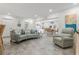 Inviting living room with an open layout flows into a kitchen with modern coastal-themed decor at 13035 91St Ave, Seminole, FL 33776