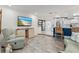 Open-concept living room featuring a TV, modern furniture, and seamless transition to the kitchen area at 13035 91St Ave, Seminole, FL 33776