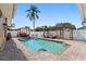 Relaxing backyard pool featuring a pergola with lounge seating, patio and refreshing water feature at 13035 91St Ave, Seminole, FL 33776
