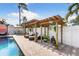 Relaxing poolside featuring shaded lounge areas, open patio space, lush landscaping and outdoor decor at 13035 91St Ave, Seminole, FL 33776
