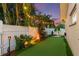 Lush backyard putting green with ambient lighting, perfect for leisurely evenings and outdoor enjoyment at 13035 91St Ave, Seminole, FL 33776