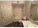 Bathroom with shower and tub combo, toilet, modern vanity and new floors at 13243 Sanctuary Cove Dr # 204, Temple Terrace, FL 33637