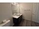 Bathroom features an updated vanity with sink, modern lighting, and new floors at 13243 Sanctuary Cove Dr # 204, Temple Terrace, FL 33637
