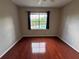 This bedroom offers hardwood floors, neutral paint and view of the community pool at 13243 Sanctuary Cove Dr # 204, Temple Terrace, FL 33637