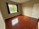 This bedroom offers hardwood floors, natural light, and view of the community pool at 13243 Sanctuary Cove Dr # 204, Temple Terrace, FL 33637