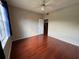 This bedroom offers hardwood floors, natural light, and standard ceiling fan at 13243 Sanctuary Cove Dr # 204, Temple Terrace, FL 33637