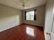 Comfortable bedroom featuring wood floors and natural light from a window at 13243 Sanctuary Cove Dr # 204, Temple Terrace, FL 33637