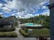 Beautiful community pool, lounge chairs, palm trees and lush landscaping at 13243 Sanctuary Cove Dr # 204, Temple Terrace, FL 33637