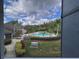 Beautiful community pool, lounge chairs, palm trees, lush landscaping and view from unit at 13243 Sanctuary Cove Dr # 204, Temple Terrace, FL 33637