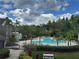 Beautiful community pool, lounge chairs, palm trees and manicured landscaping at 13243 Sanctuary Cove Dr # 204, Temple Terrace, FL 33637