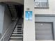 Building signage shows unit numbers above gray private garages, stairs, and walkways at 13243 Sanctuary Cove Dr # 204, Temple Terrace, FL 33637