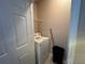 Cozy laundry area featuring a washing machine and storage shelf for convenience at 13243 Sanctuary Cove Dr # 204, Temple Terrace, FL 33637